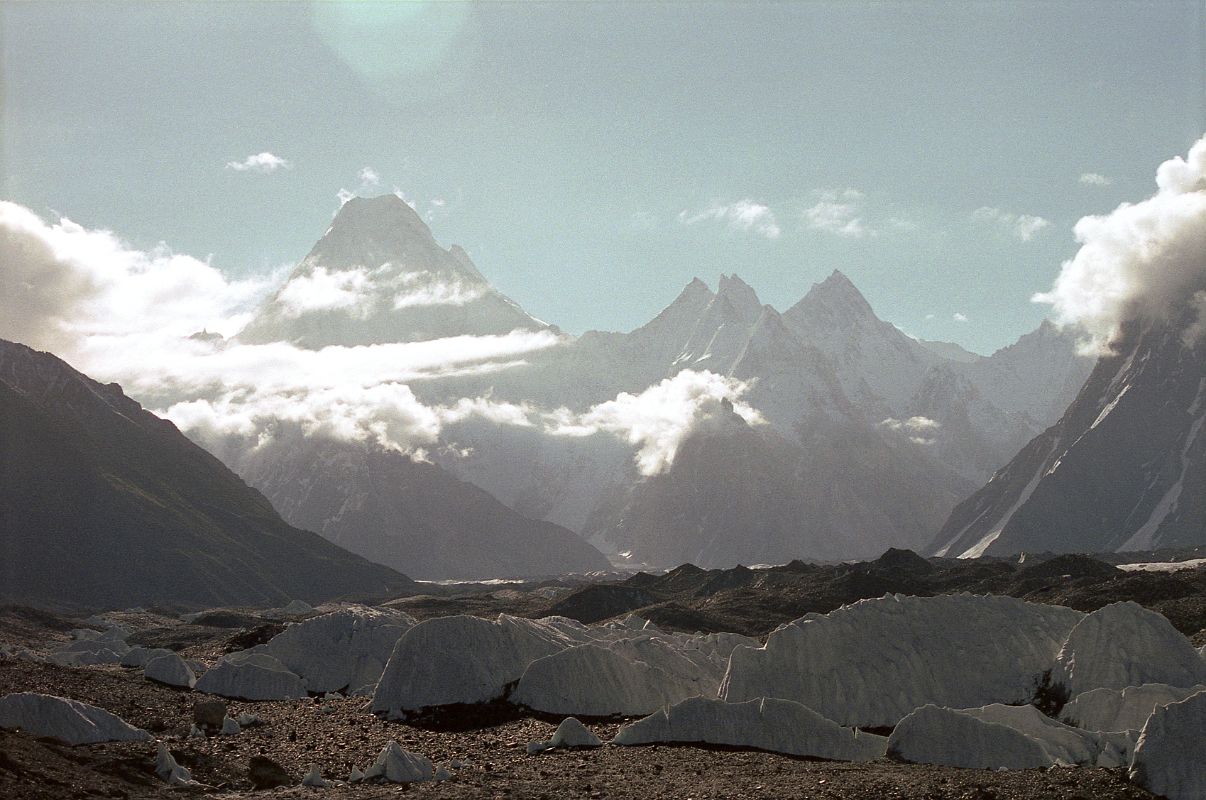 23 Gasherbrum IV, Gasherbrum II, Gasherbrum VII, Gasherbrum Twins, Gasherbrum V and Gasherbrum VI From Goro II When I looked ahead on the Baltoro Glacier, I could see the sun coming over the top of Gasherbrum IV (7925m) with Gasherbrum II peaking out to its right. After the col (6493m) the ridge rises to the Gasherbrum VII (6955m), the Gasherbrum Twins (6882m), Gasherbrum V (7147m) and further to the right Gasherbrum VI (7003m).